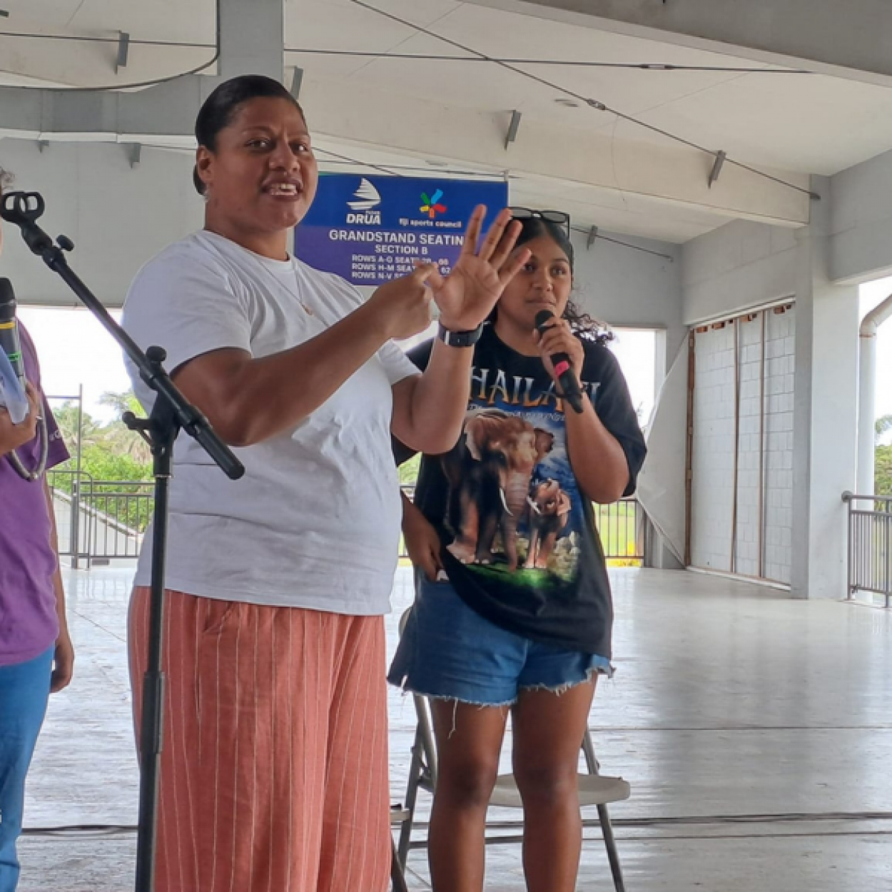 Speakers at FWRM's intergenerational panel. One of them is communicating with the crowd using Fijian Sign Language.