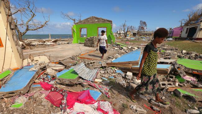 Women walk among the destroyed homes in the wake of Cyclone Winston in Fiji. Photo: Lyndon Mechielsen/The Australian