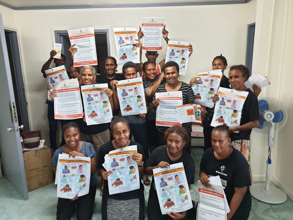 MicrosoftTeams-image (5) A group of fourteen men and women from the family support centre in the Solomon Islands hold up posters