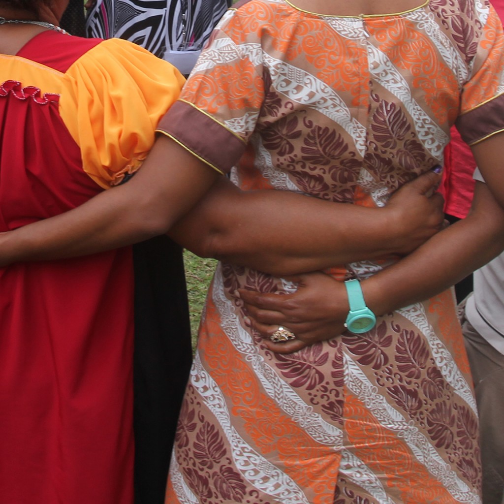 Pacific women linking arms