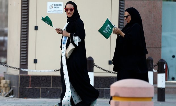 Saudi women hold national flags during Saudi National Day in Riyadh, Saudi Arabia Friday. Photo: Faisal Al Nasser/Reuters