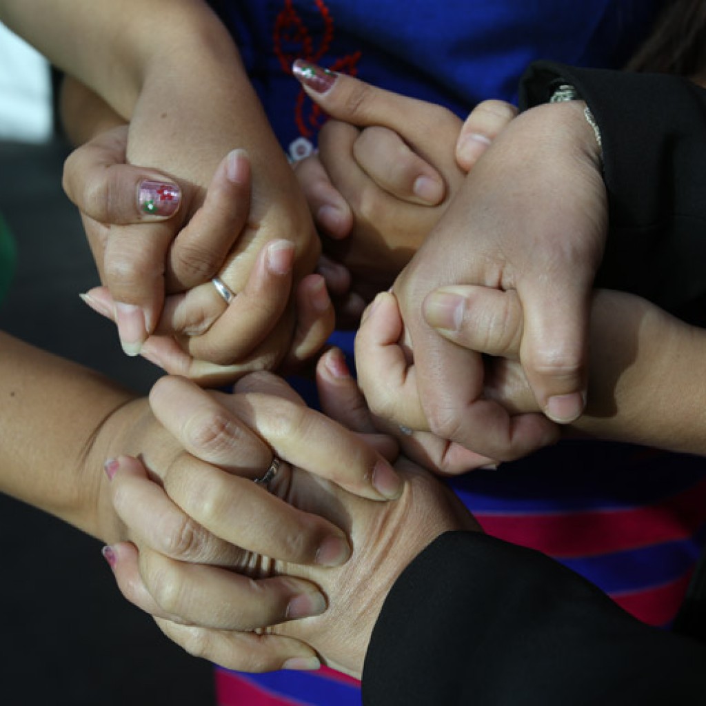 Women holding hands