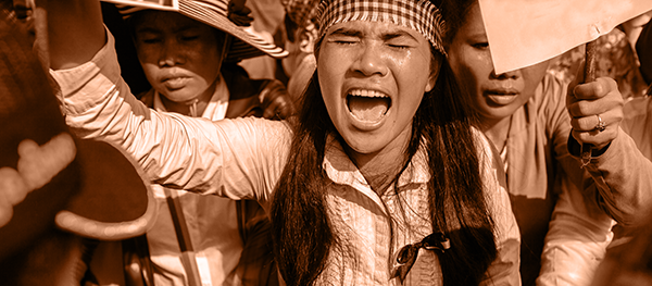 orange-tax Image of a woman protesting.