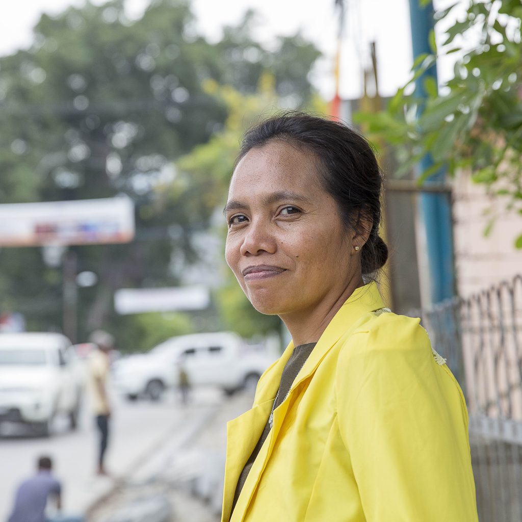 Image of Alzira standing on a street, looking to the camera.